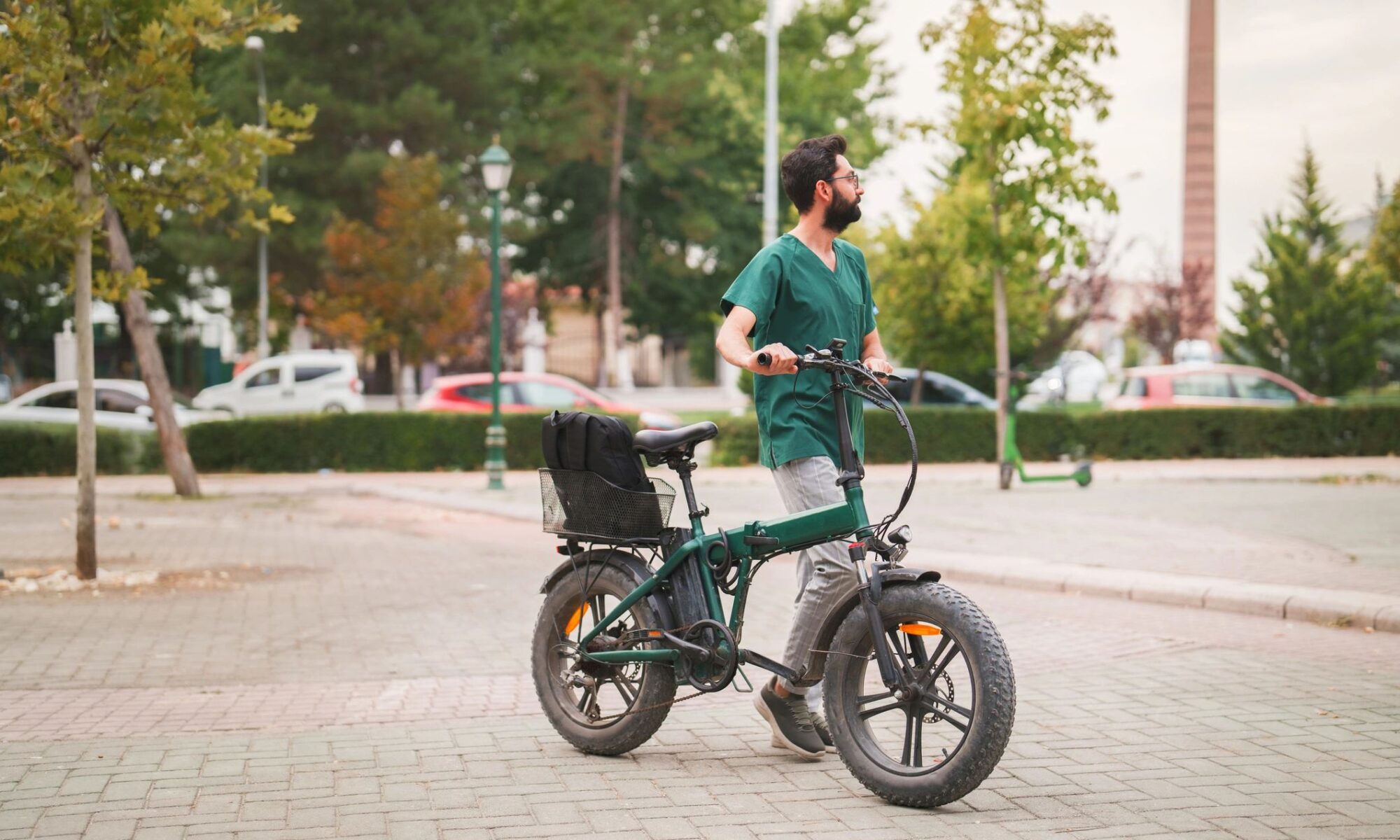 Health Worker after work, walking with Electric Bike Ride